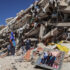 People and rescuers search for victims amid debris of a demolished building on June 27 in La Guaira, Venezuela, after a 7.2-magnitude earthquake struck the region. Photo: Edilzon Gamez/Getty Images.