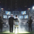 AI generated image depicting Lionel Messi and Benjamin Natanyahu standing before a wall of surveillance screens displaying maps, surrounded by armed personnel, drones, and a large crowd waving Israeli flags. Photo: MintPress News.