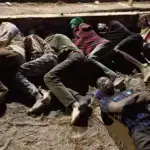 Migrants who crossed into Spain from Morocco sleep on a Ceuta beach, August 3 2026. Photo: Morning Star.