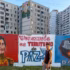 Passerbyer walks in front of a banner that reads “Venezuela is a Peace Territory” in Ciudad Tiuna, Venezuela. Photo: Roger D. Harris.