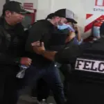 Bolivian police escort Fernando Cerimedo, an adviser to Bolivia's President Rodrigo Paz and a key digital strategist for Argentinian President Javier Milei, after a court ordered his preventive detention in Santa Cruz, Bolivia, August 21, 2026. Photo: Ipa Ibanez/Reuters.
