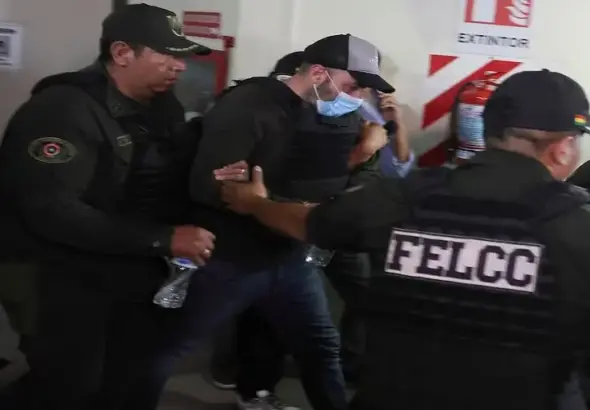 Bolivian police escort Fernando Cerimedo, an adviser to Bolivia's President Rodrigo Paz and a key digital strategist for Argentinian President Javier Milei, after a court ordered his preventive detention in Santa Cruz, Bolivia, August 21, 2026. Photo: Ipa Ibanez/Reuters.