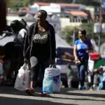 A woman carries bags while shopping at a street market in the Petare neighborhood of Caracas, Venezuela, January 8, 2026. Photo: Jesús Vargas/Getty Images/file photo.